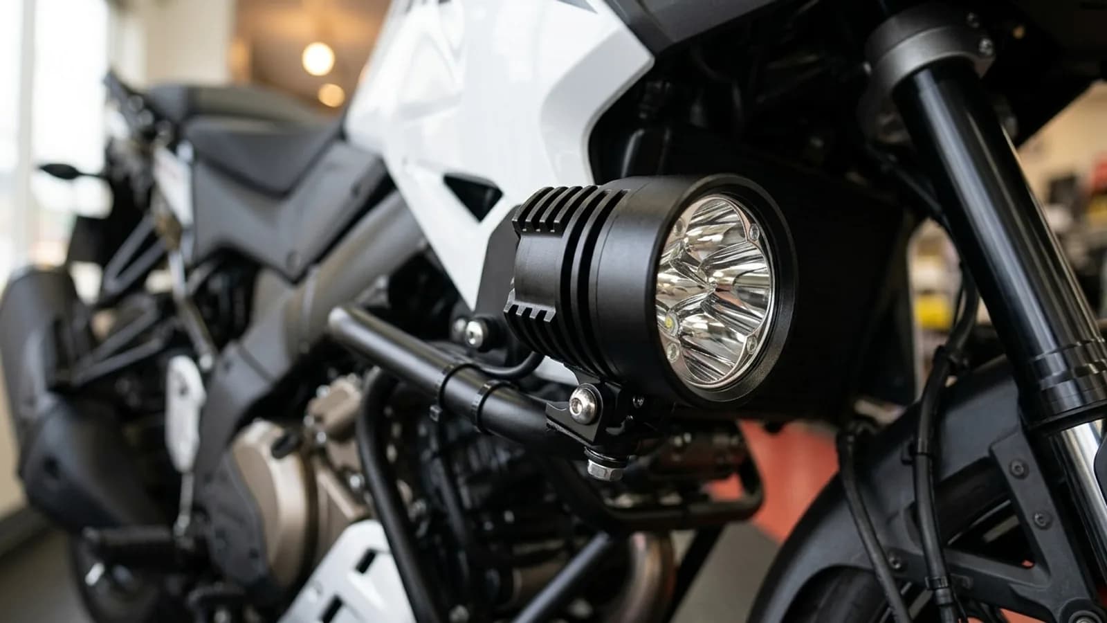 Détail du collier de fixation d'un feu additionnel LED Next-Tech sur le crash bar de la Suzuki V-Strom