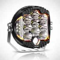 phare LED rond Next‑Tech 130w 18cm 20000 lumens avec feux de jour orange sur fond studio, vue trois-quarts